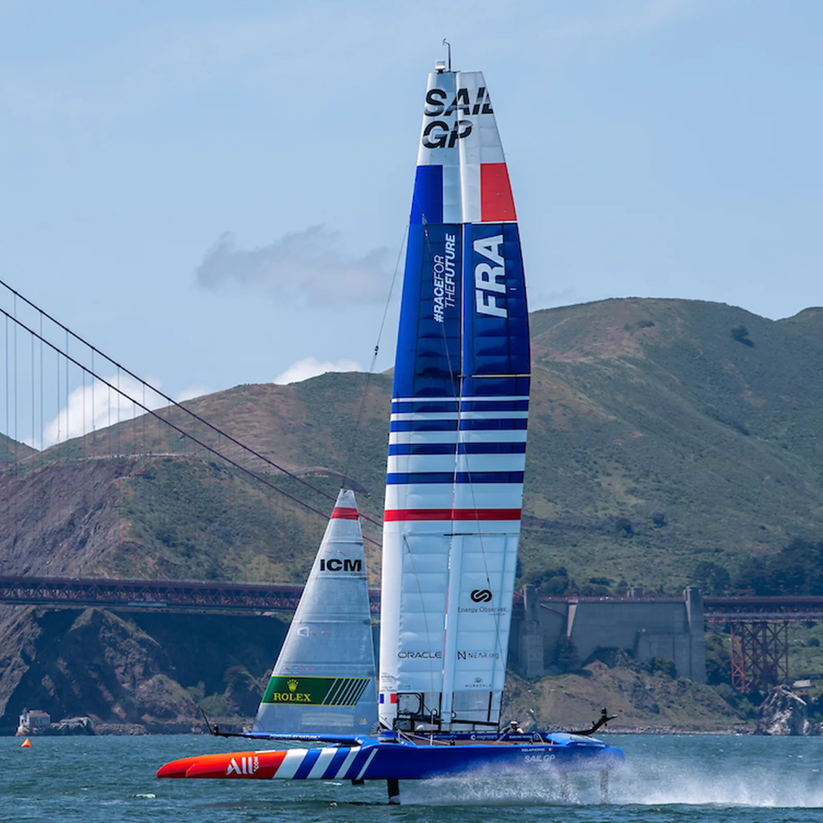 France SailGP F50 catamaran on the water with the Golden Gate Bridge behind it.